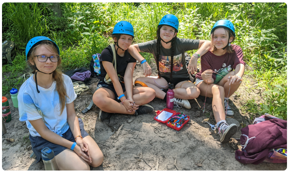 Cadette girls posing for photo at the high rope course