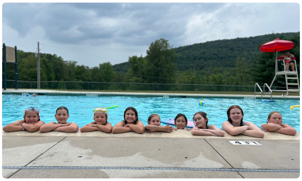 Junior girls posing for photo in the Camp Small Valley pool